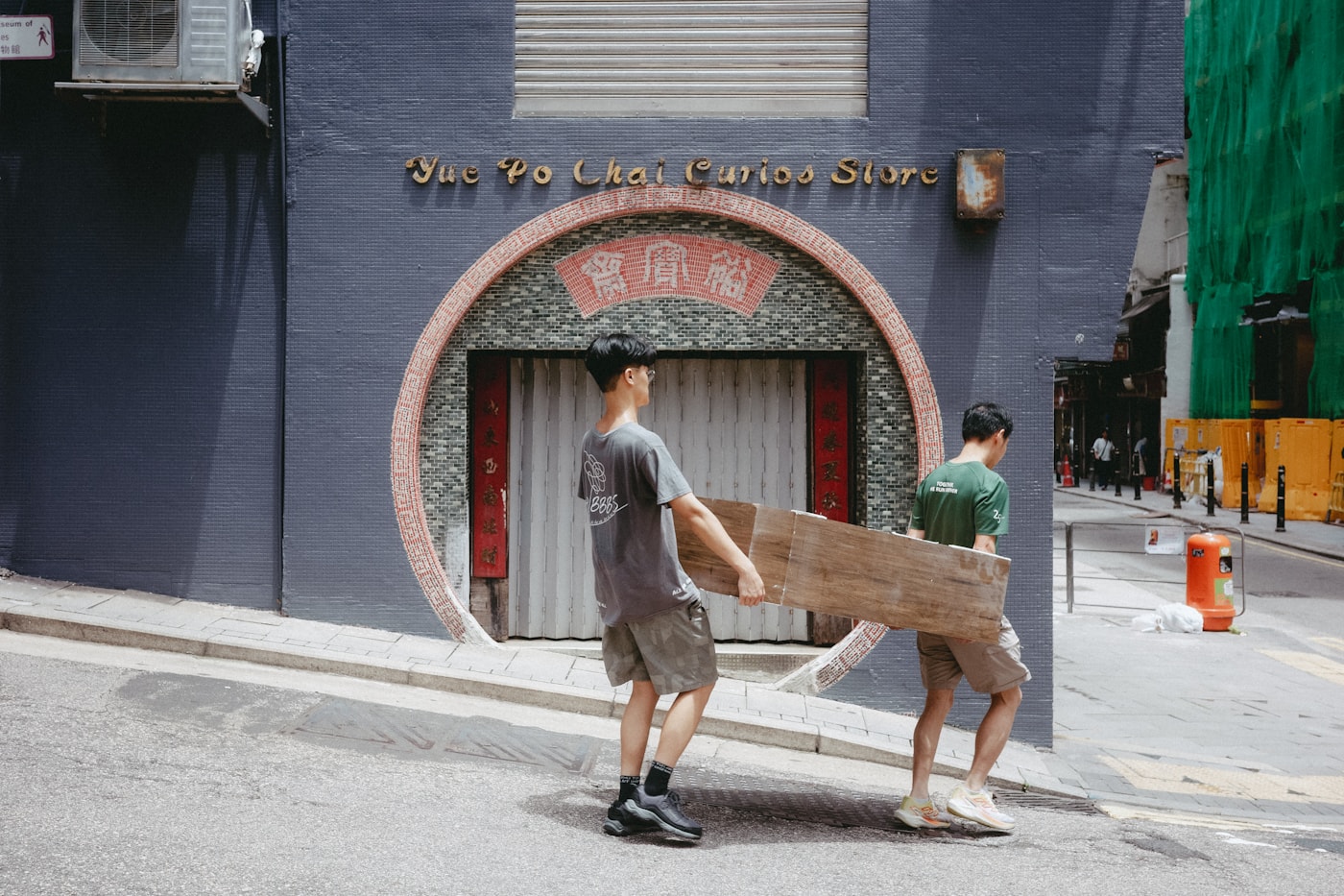 Hustle and Muscle crew carrying furniture through the city